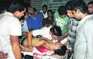 Relatives and friends shift Ishan Kumar to a hospital in Jalandhar on Monday night.