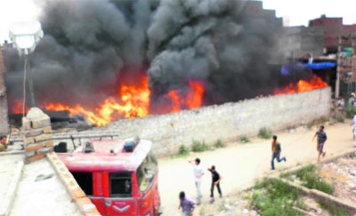 Firemen try to control fire caught by waste hosiery material at Subhash Nagar in Ludhiana on Tuesday evening.