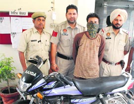Rape accused in police custody with stolen motorcycle in Ludhiana on Tuesday.