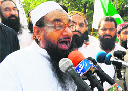 LeT founder Hafiz Saeed addresses a rally in Lahore on Tuesday after US Secretary of State Hillary Clinton urged Pakistan to do more to curb terror. 