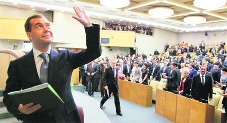 Former Russian President Dmitry Medvedev waves after Russias lower house of Parliament overwhelmingly confirmed Medvedev as the Prime Minister after he was nominated by newly inaugurated President Vladimir Putin