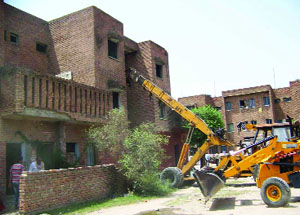 Residential quarters in the Housing Board Colony being demolished in Ferozepur on Wednesday. 
