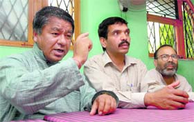 Shamsher Singh Bisht of Lok Vahini (left) addresses a press conference in Dehradun on Wednesday