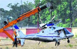 The wreckage of Jharkhand CM Arjun Mundas helicopter that crashed while landing at the Birsa Munda airport being removed using a crane in Ranchi on Wednesday; 