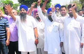 Members of the Mini Bus Operators Association hold a protest in front of the DC office against the proposed diesel price hike in Jalandhar on Wednesday