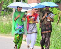 Girls protect themselves from scorching heat in Ludhiana. photo: inderjeet verma