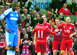 Liverpool's Jordan Henderson (2R) celebrates after scoring against Chelsea at Anfield, Liverpool, on Tuesday. Liverpool won 4-1