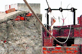 High tension wires dangle over houses in Indira Colony in ward number 14 in Amritsar.