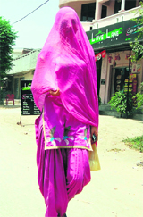 A girl uses her dupatta to cover herself up on a hot afternoon in Amritsar on Thursday.