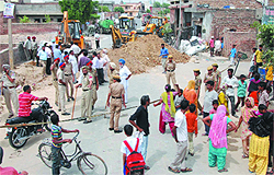The BMC workers completing the storm-sewer water project amid tight security in Bathinda on Thursday