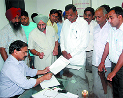 Congress councillor Jagroop Singh Gill along with residents of the trans-railway line areas submiting a memorandum to the assistant commissioner of municipal corporation, Kamal Kant, on Thursday