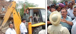 (Left) The Bathinda Municipal Corporation had initiated a demolition drive in Kanhaiya Nagar on Friday; But the drive had to be aborted after a crowd, aided by BJP workers, protested against the action of the corporation. 