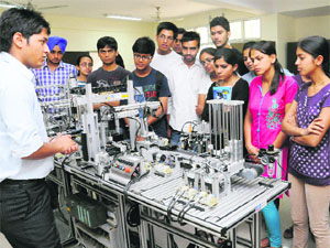 Students take a look at machines on display at the Central Scientific Instruments Organisation in Chandigarh on Friday.