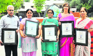 Principals pose with their citations at the Government Model Senior Secondary School in Chandigarh on Friday.