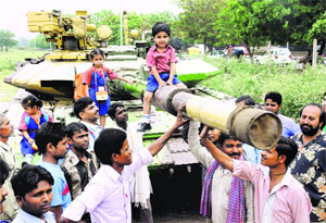 Schoolchildren have a look at Army equipment on display at Sector 34 in Chandigarh on Friday.