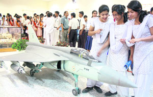 Girls watch the prototype of Tejas aircraft on Technology Day at Instrument Research and Development Establishment in Dehradun on Friday.