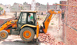 The Municipal Corporation demolishes illegal structures near Sector 48 in