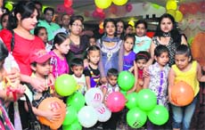 Accompanied by their mothers, children participate in different games at a fast food joint to celebrate Mother's Day in Jalandhar on Friday.