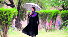 A girl uses an umbrella on a hot summer afternoon in University of Jammu on Friday.