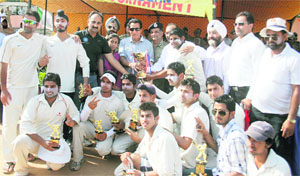 Minister for Youth Services and Sports RS Chib presents a trophy to the winning team at Parade Ground in Jammu on Friday. 