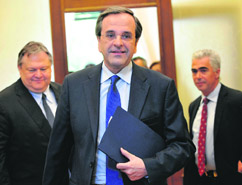 New Democracy leader Antonis Samaras (C) leaves after meeting with socialist party leader Evangelos Venizelos (L) in Athens 