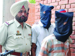 Two of the accused in police custody in Amritsar on Saturday. photo: Vishal Kumar 