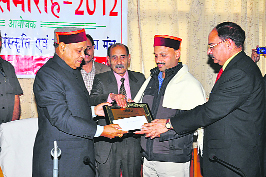 Chief Minister PK Dhumal presents a Yuva Shikhar Sahitya Samman to Dr Bharat Prasad, writer from Meghalaya, at a function organised by literary organisation Shikhar