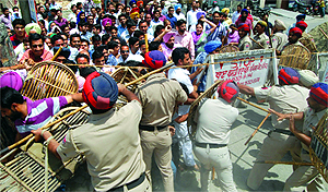 Police uses force to disperse the protesting contractual SSA teachers outside the residence of Local Bodies Minister Bhagat Chunni Lal in Jalandhar on Saturday