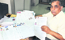 Councillor of Ward Number 9 Gurmeet Chand Duggal shows forms for including names in voters' list and filing objections in Jalandhar on Friday