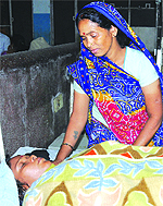 Tara's mother Gayatri tends to her at the Civil Hospital in Jalandhar on Saturday