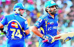 Mumbai Indians Rohit Sharma (R) and Herschelle Gibbs run between the wickets during their match against Kolkata Knight Riders at the Eden Gardens in Kolkata on Saturday. Rohit scored an unbeaten 109 as Mumbai won the match by 27 runs