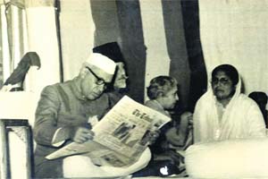 Jawaharlal Nehru reading a copy of the Tribune