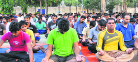 Inmates of the Model Jail meditate during a camp organised by the Art of Living in Chandigarh on Sunday.