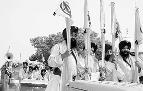 Devotees take part in the ‘fateh’ march at Chhapar Chhiri village in Mohali district on Sunday.
