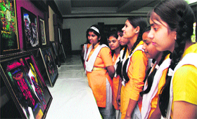 Schoolchildren have a look at the paintings of the late HN Mishra, an eminent painter from Dehradun, during an exhibition in Dehradun on Sunday.
