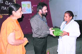 Dr Arun Sharma, medical superintendent, Government Hospital Sarwal, Jammu, honours a nurse as part of Nursing Day celebrations at BN Hospital in Jammu