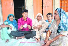 A victim family shows the picture of a farmer who ended life