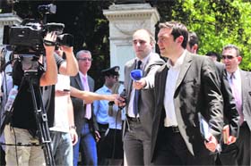 Leader of the Radical Left coalition Alexis Tsipras speaks to the media after a meeting with Greek President Carolos Papoulias in Athens on Sunday