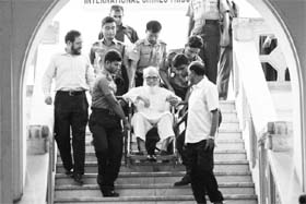 Ghulam Azam (in wheelchair), former head of the opposition Jamaat-e-Islami party, being brought out of the International Crimes Tribunal in Dhaka on Sunday