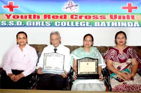 President of SSD Girls College, Bathinda, Nand Lal Garg and principal Parminder Kaur Tanghi with the awards presented to them at a function held in Chandigarh recently