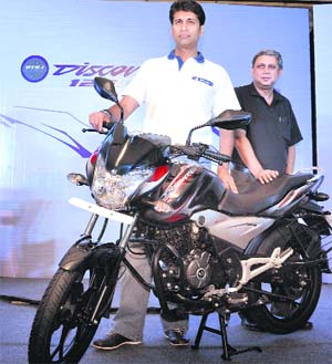 Bajaj Auto MD Rajiv Bajaj (L) with K. Srinivas, president, motorcycle business, with the firms new Discover 125cc ST motorbike in New Delhi on Monday