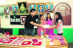 District Magistrate, Almora, Akshat Gupta, gives away gifts to students in Almora on Monday. 