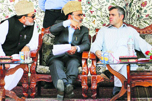 Chief Minister Omar Abdullah discusses a point with Parliamentary Affairs Minister Ali Mohammad Sagar (centre) while a senior party leader looks on during a function in Srinagar on Monday. 