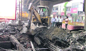MC workers repair a caved in portion of a road in Ludhiana on Monday. The action was delayed even though the MC had been intimated about the road several days ago.