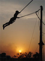 A child enjoys a swing on a sweltering summer days evening at a mall in Bathinda on Tuesday. Tribune photo: Pawan Sharm