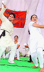 Students present a skit at the annual programme of HPU regional centre in Dharamsala