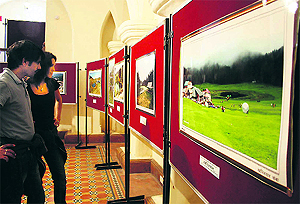 Visitors at a photo exhibition by Birbal Sharma at the Gaiety Theatre in Shimla