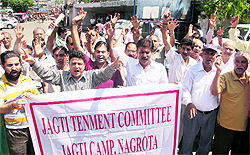 Members of the Jagti Tenement Committee, Jagti Camp, Nagrota, stage a protest in Jammu on Tuesday