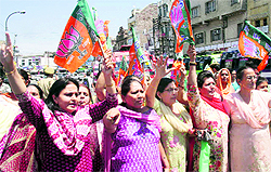 BJP Mahila Morcha activists stage a protest in front of the Power Development Department office in Jammu on Tuesday