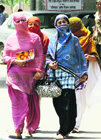 Girls protect themselves from the scorching sun in Jalandhar.